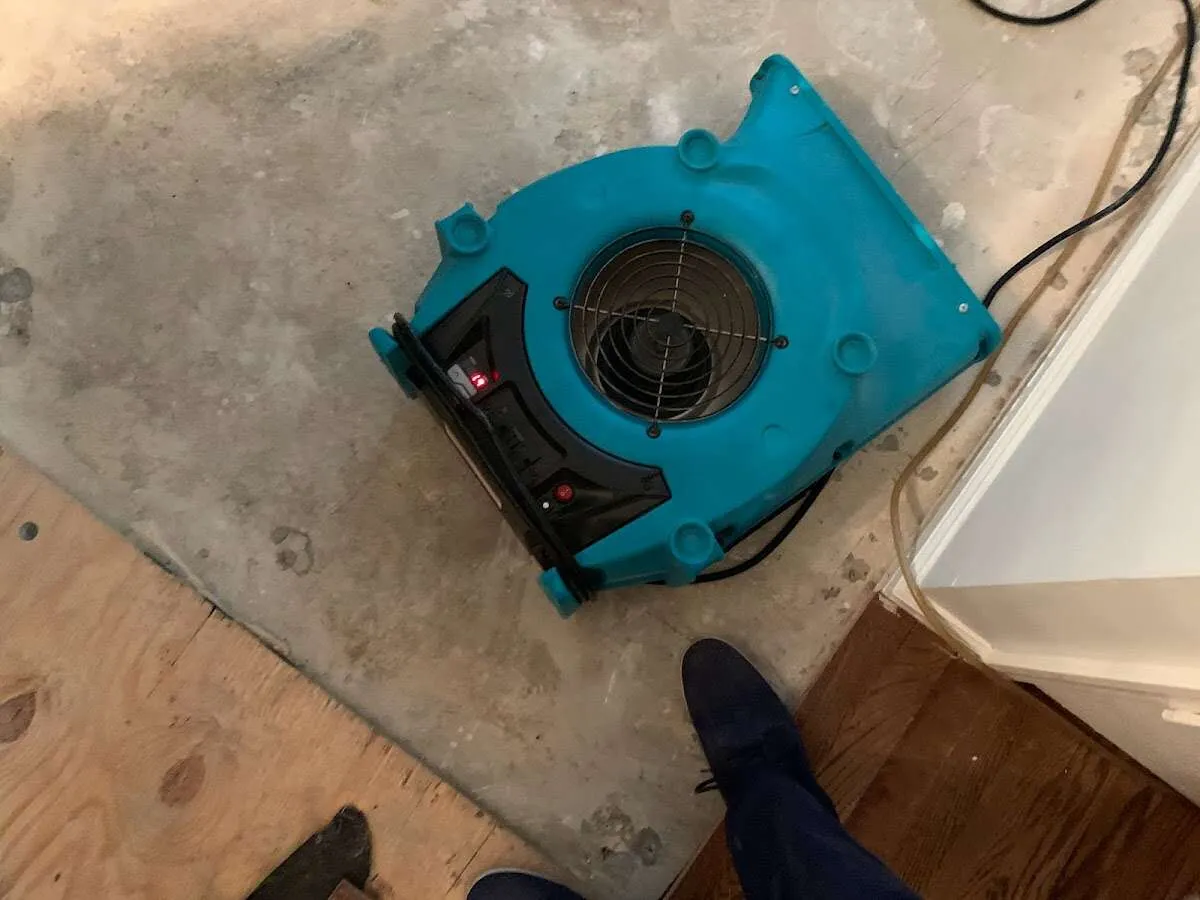 Air mover drying subfloor during Commercial Water Damage Restoration in South Elgin